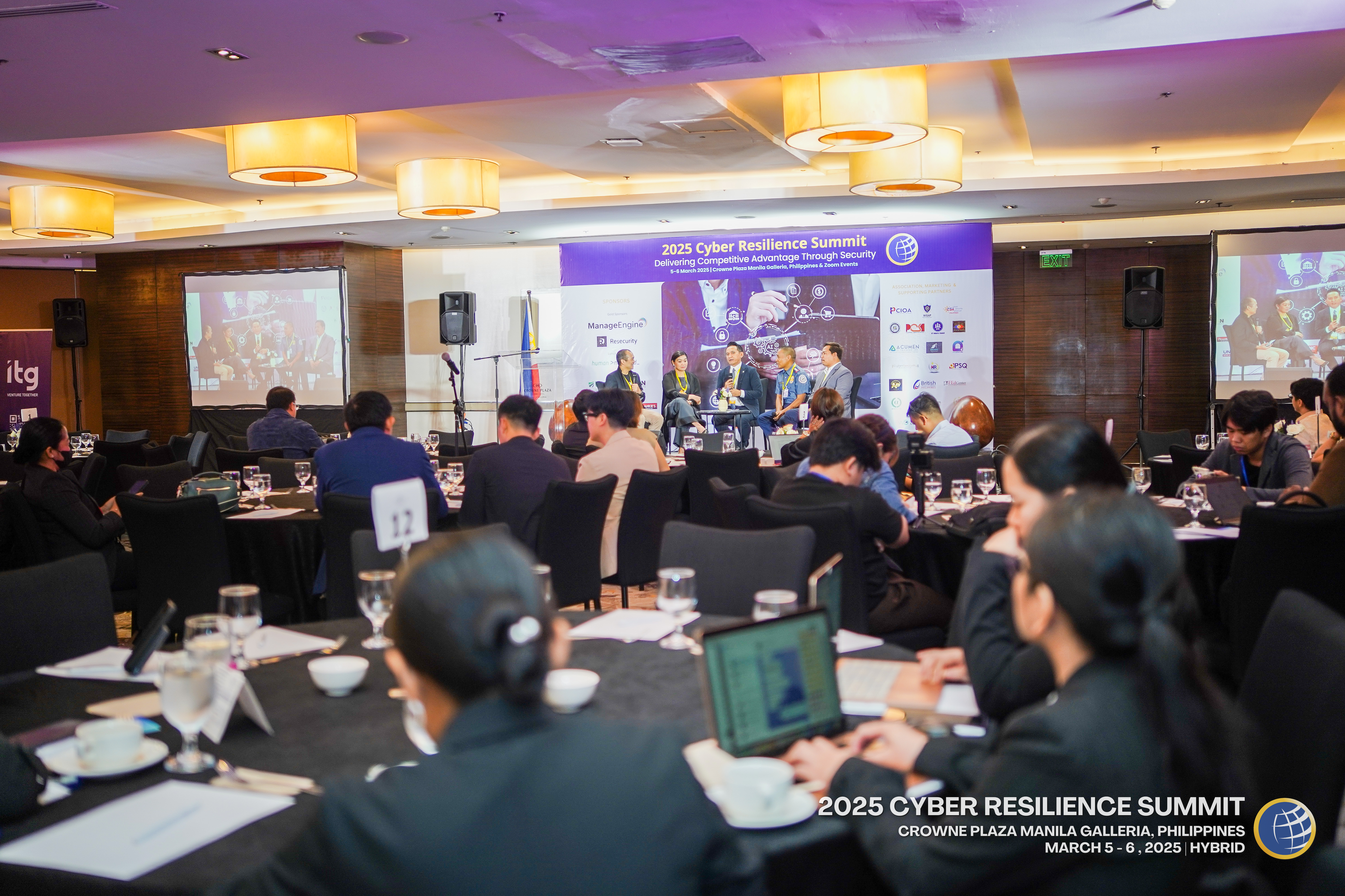 Attendees in conversation at a past summit