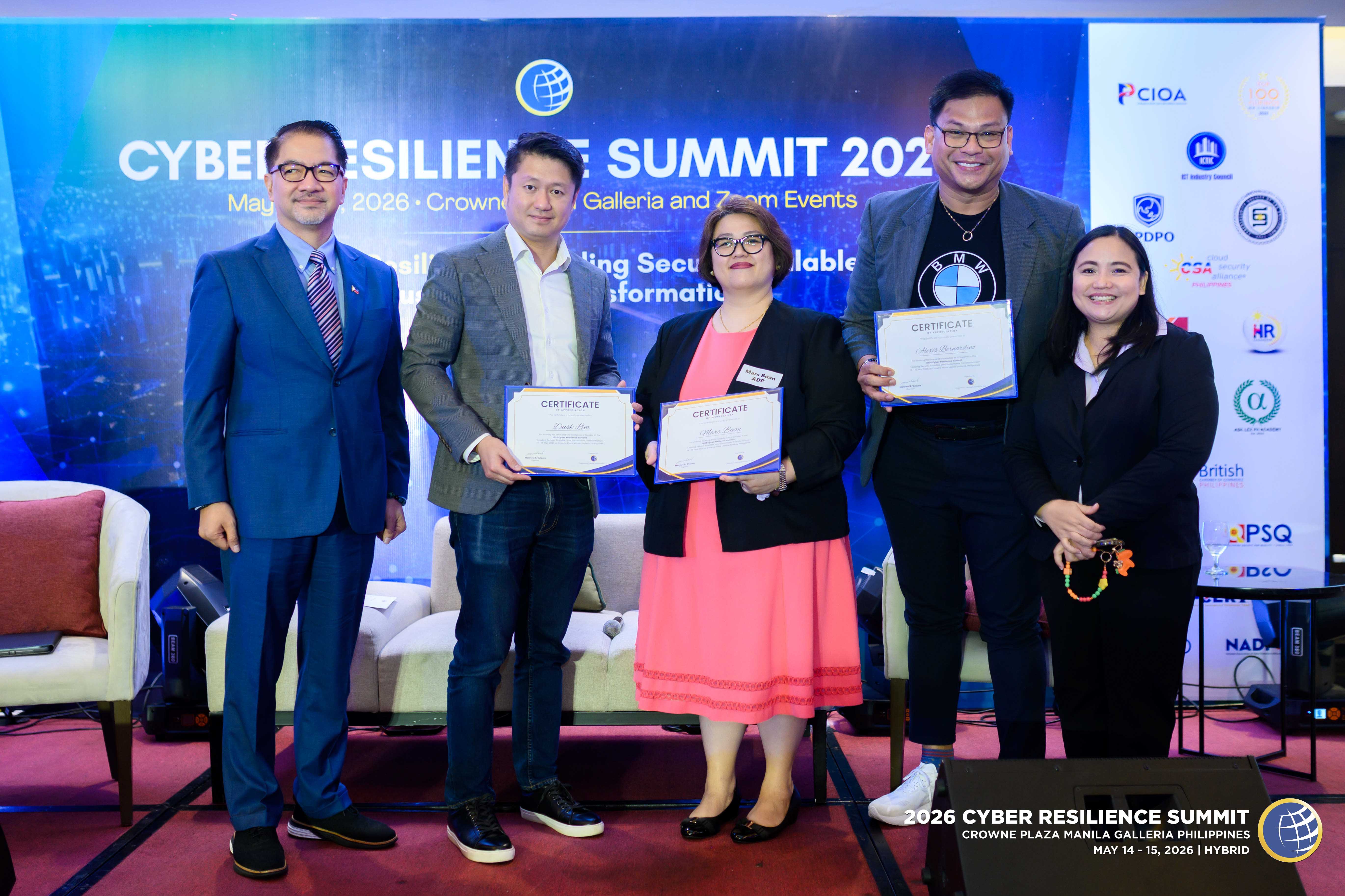 Attendees with speakers at a past summit