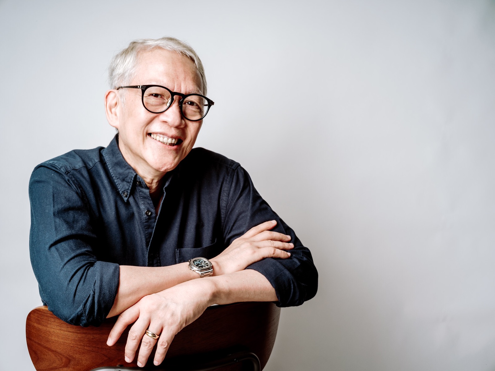 Francis Kong seated, speaking at a leadership event