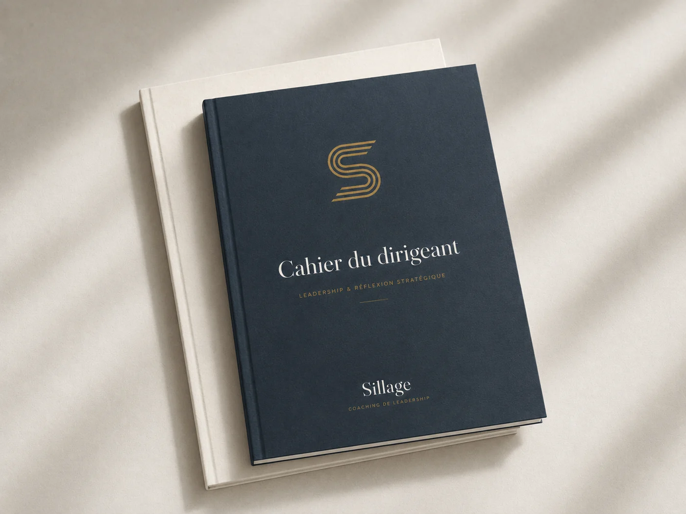Cahier du dirigeant : couverture ardoise avec symbole S laiton en tête et le mot Sillage au bas.