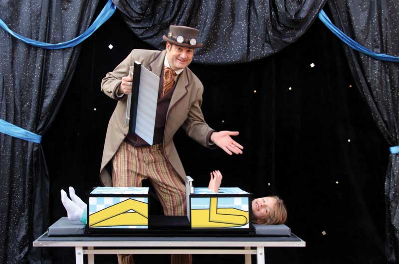 Keir performing a sawing illusion