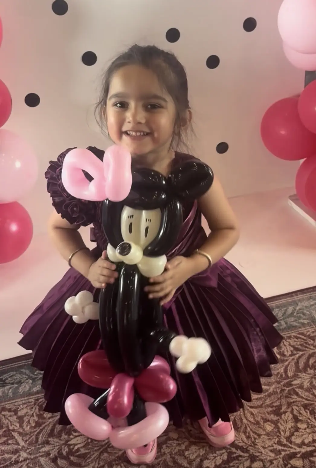 Girl holding balloon art made by Denver balloon artist Keir Royale
