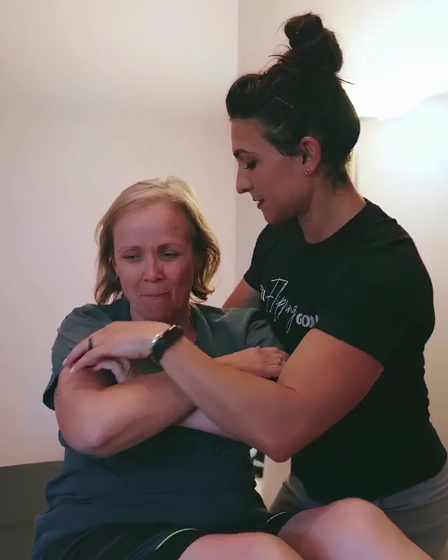 Dr. Christina supporting a patient's arm