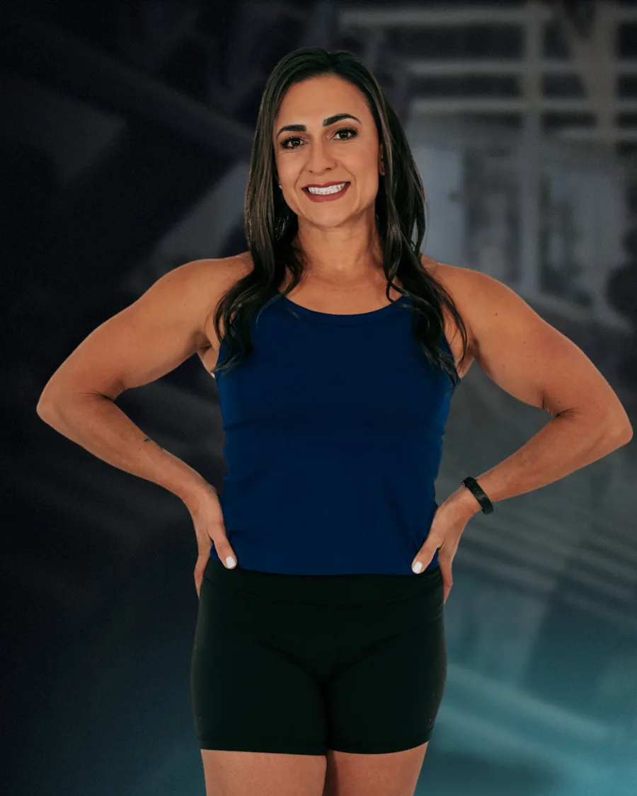 Dr. Christina Schofield, DPT, standing with hands on hips in a gym