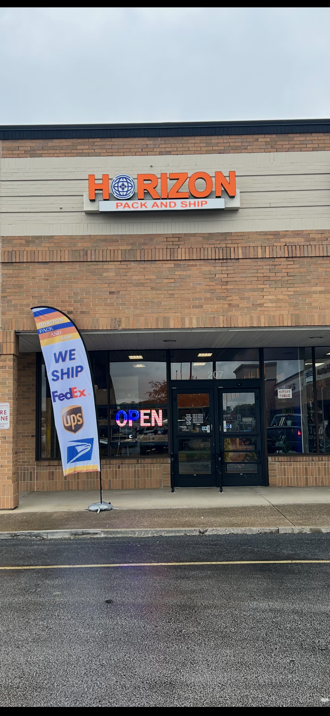 Photorealistic UPS delivery van from a different angle with the UPS logo clearly visible, uniformed UPS worker loading a package, bright daylight, natural colors.