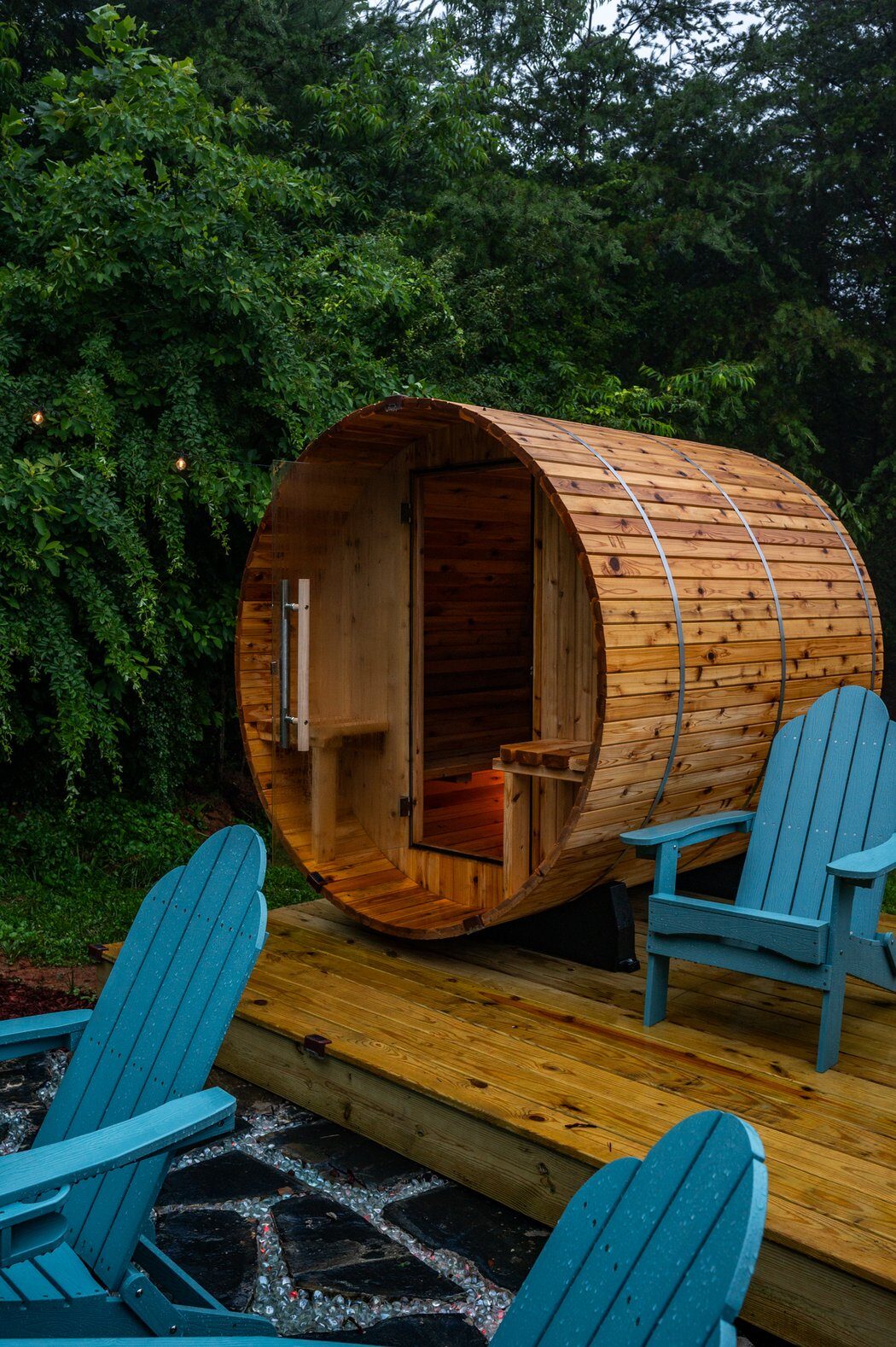 Barrel sauna and outdoor lounge area at Ashe & Ember
