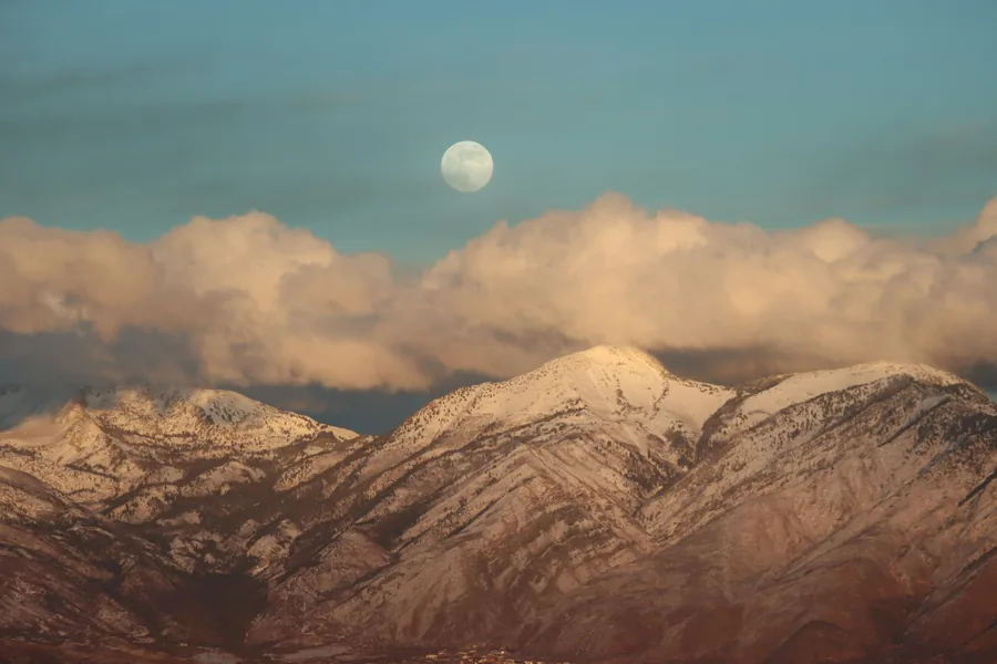 Full moon rising over snowy Wasatch peaks, photographed from Eagle Mountain, Utah