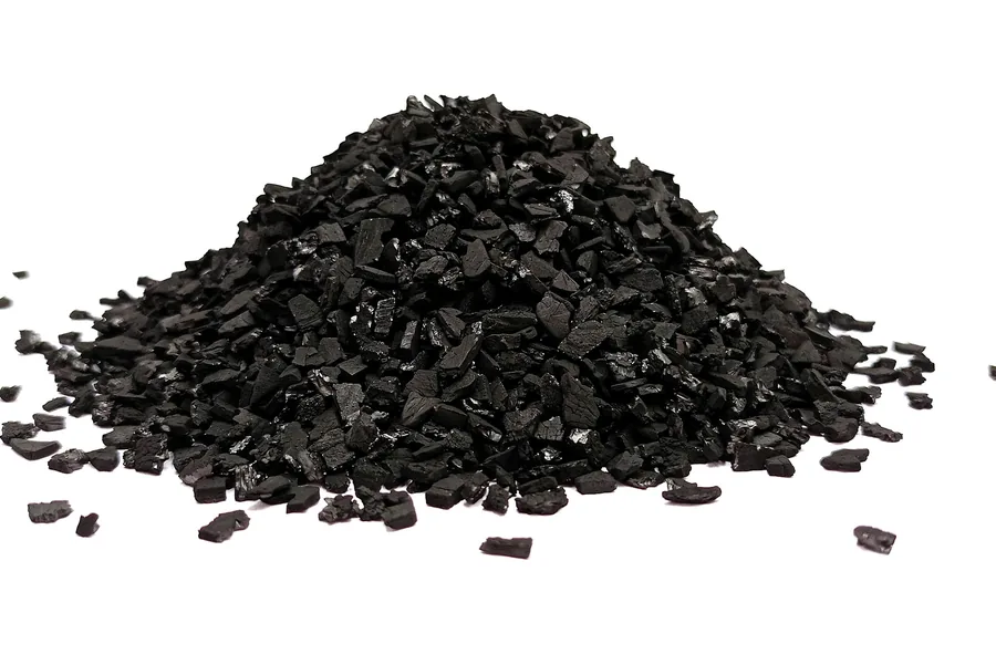 Pile of black granular carbon on a white background