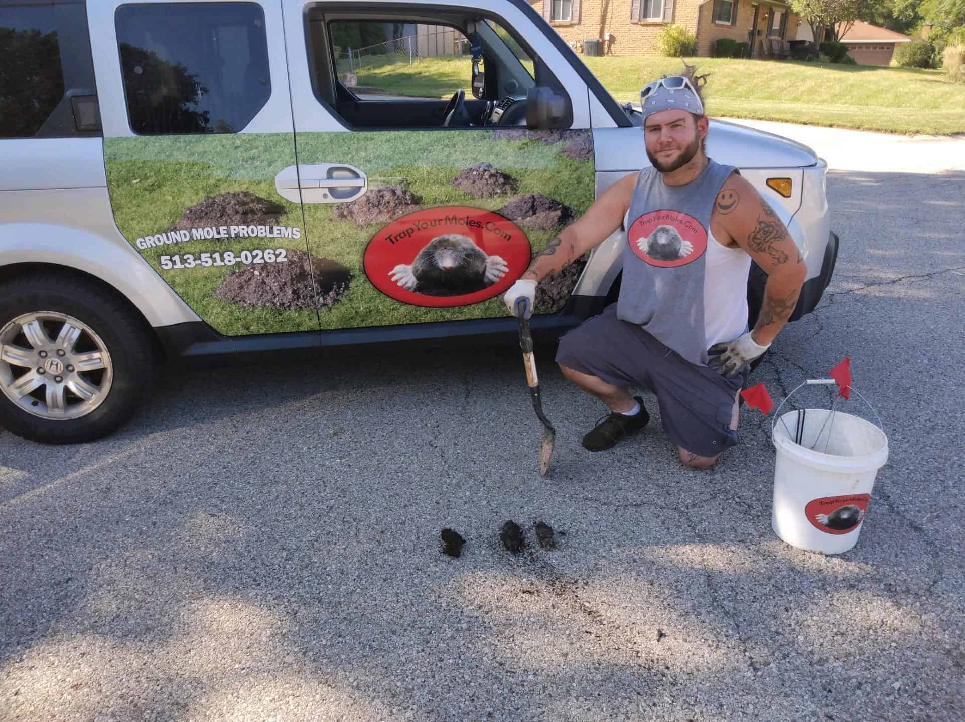 Newport mole removal: experienced Trap Your Moles technician with caught Eastern Ground Moles and branded service vehicle