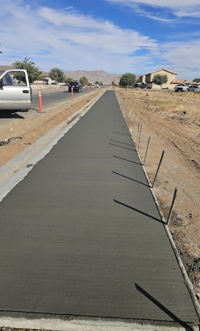 A professionally constructed straight concrete sidewalk