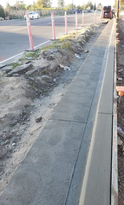 A freshly dug ditch lined with concrete