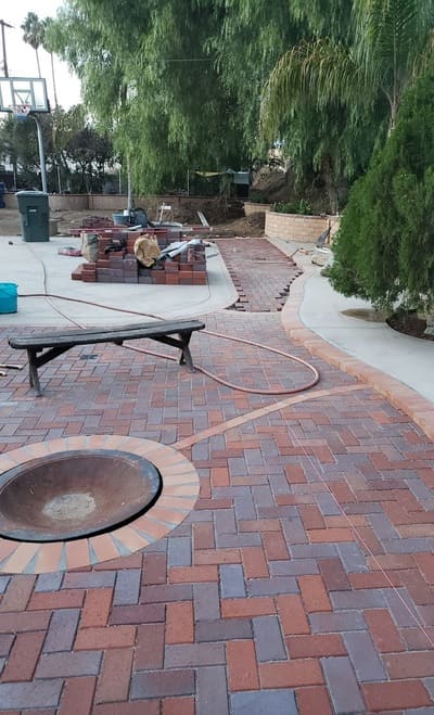 A custom paver patio featuring a built-in fire pit