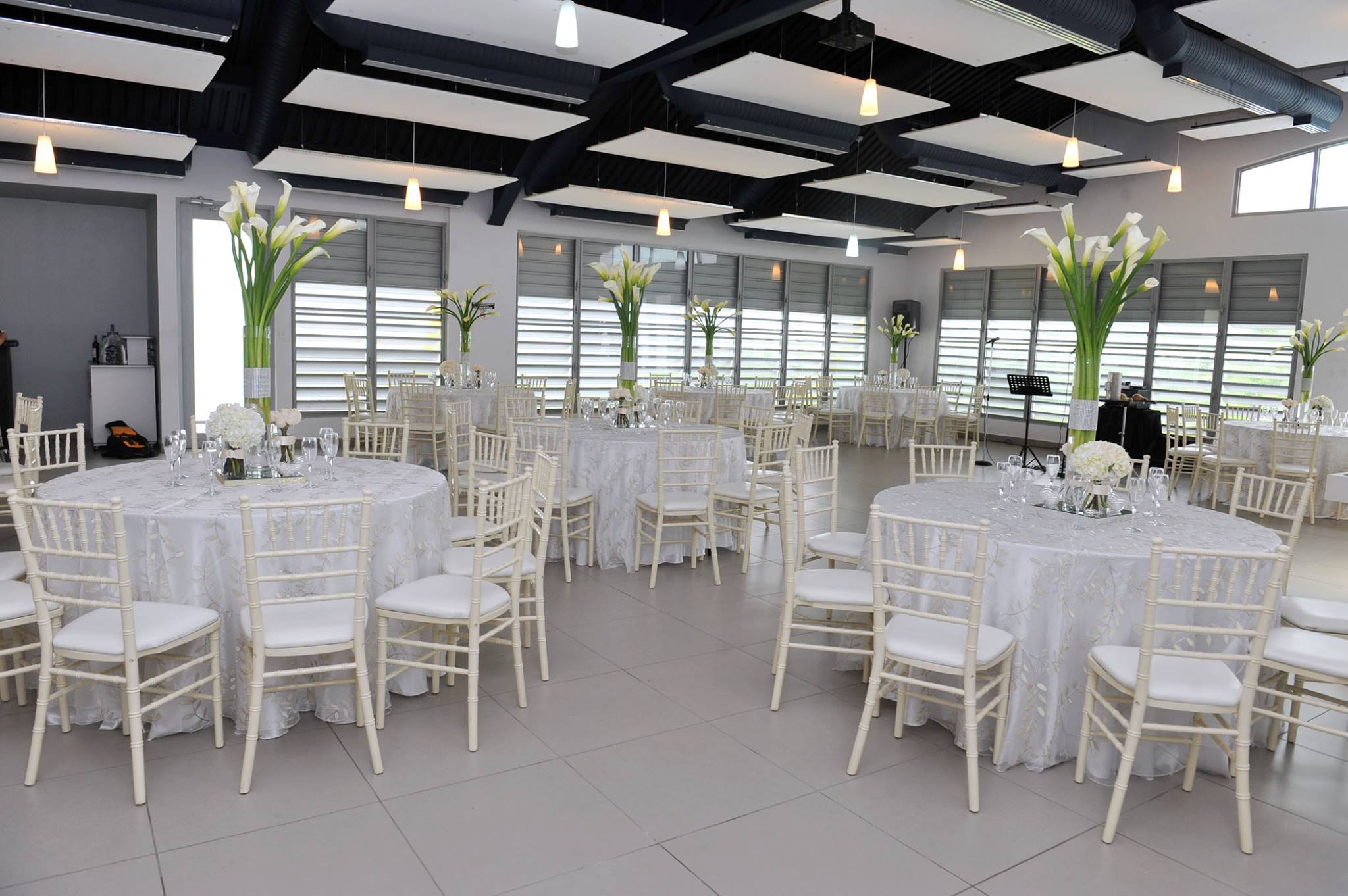 Ballroom with round tables and calla lily centerpieces