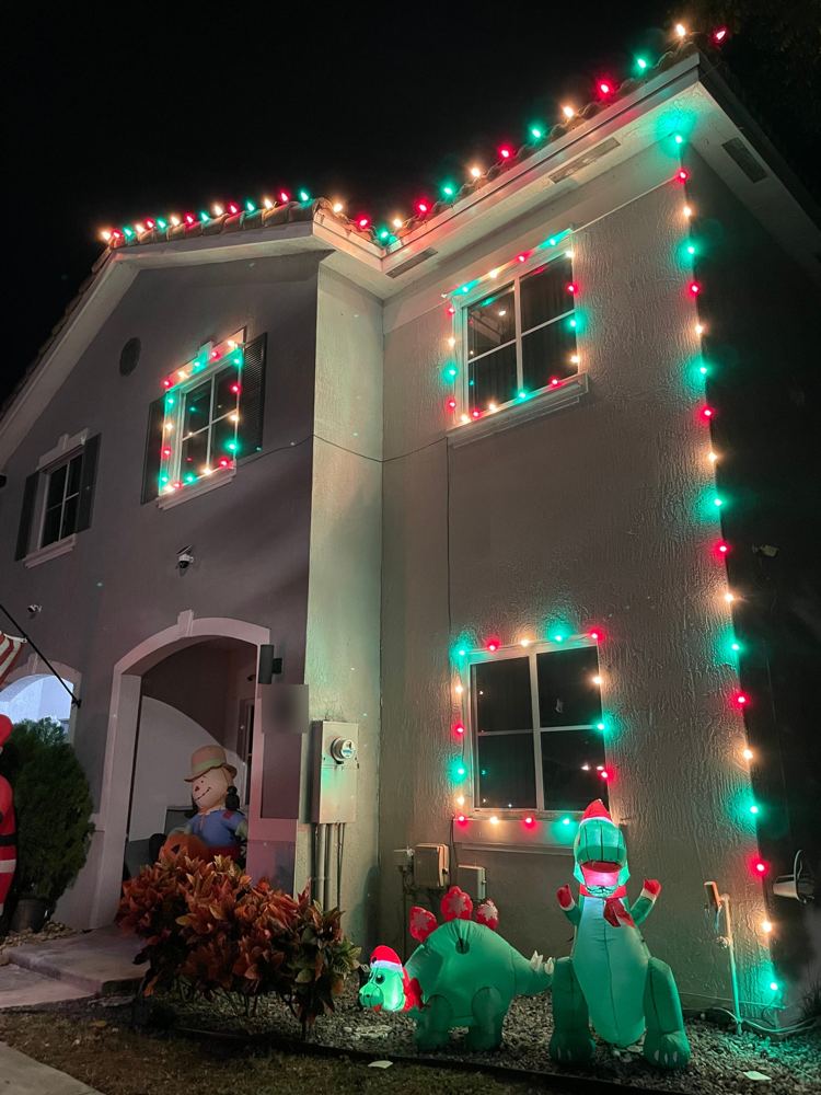 Two-story home with roofline, corner, and window outlines in red, green, and white