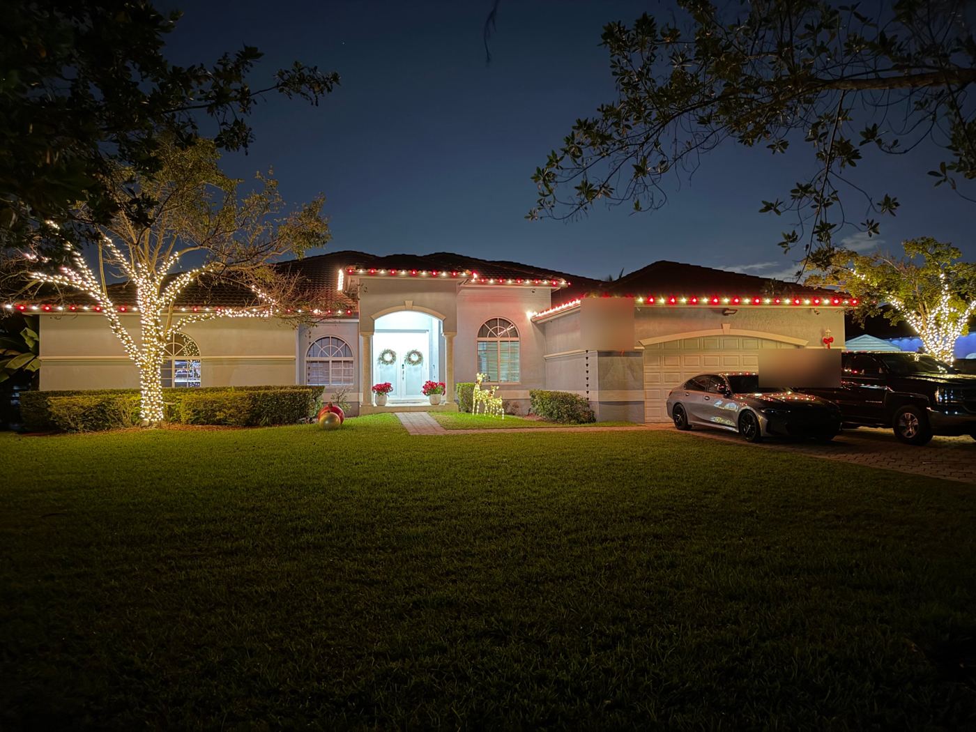 Single-story home with red and white roofline and wrapped shade trees