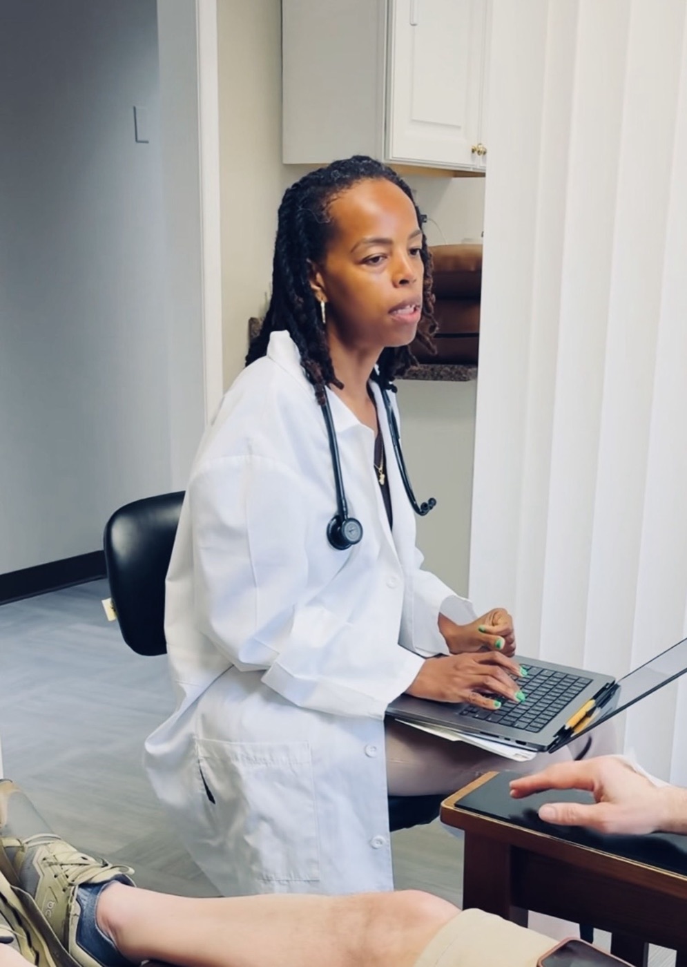 Dr. Jeanty taking notes during a patient consultation