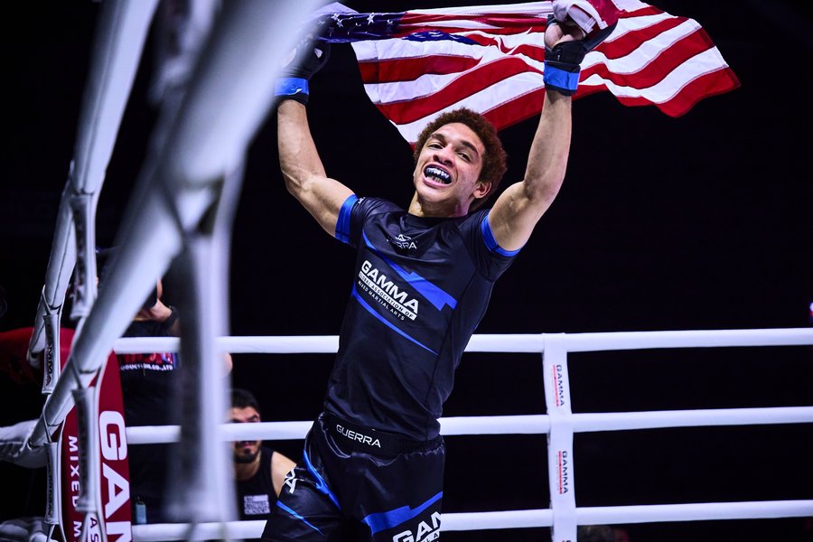 Majid Corbett celebrating MMA win raising the American flag