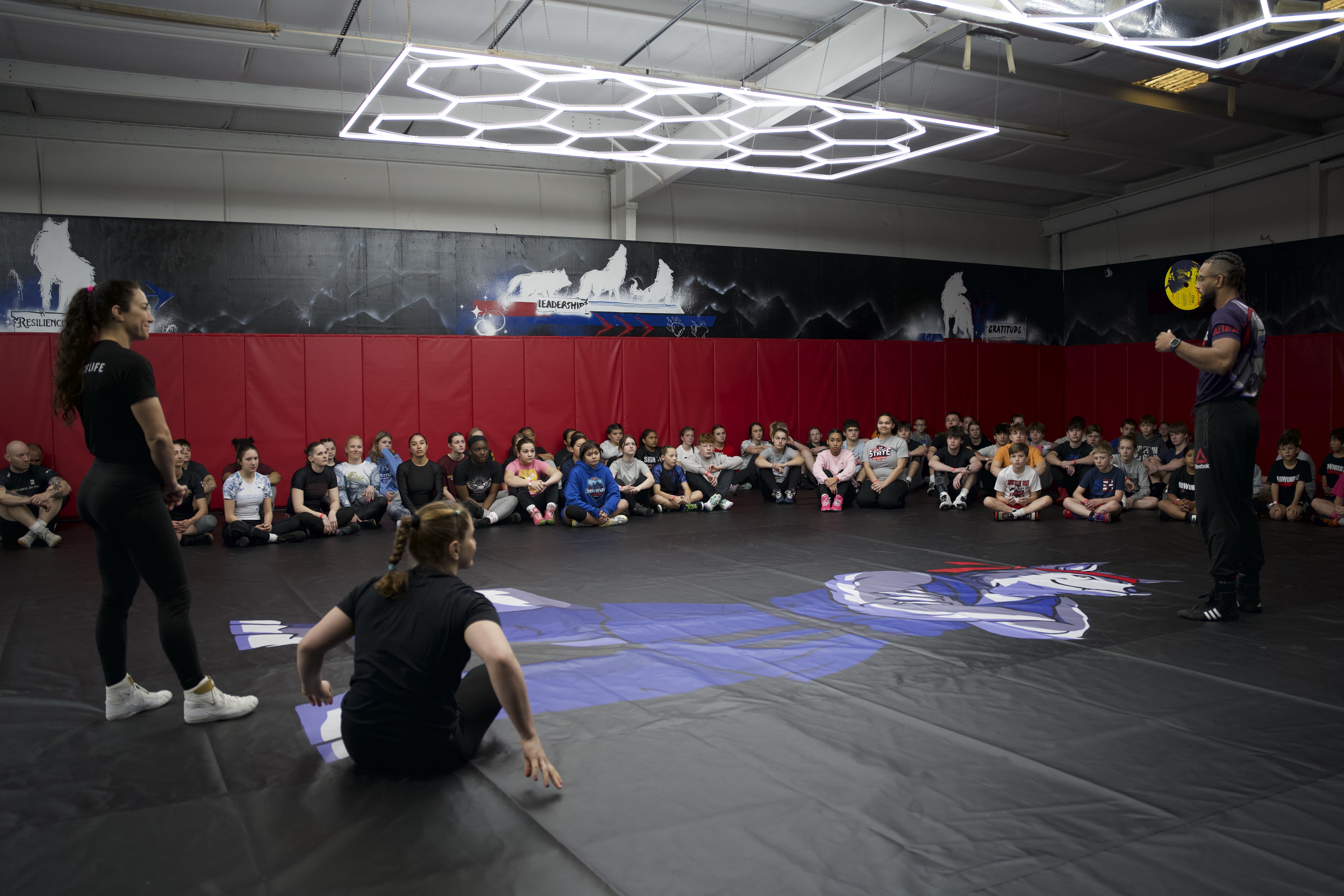 Coach instructing youth wrestling team