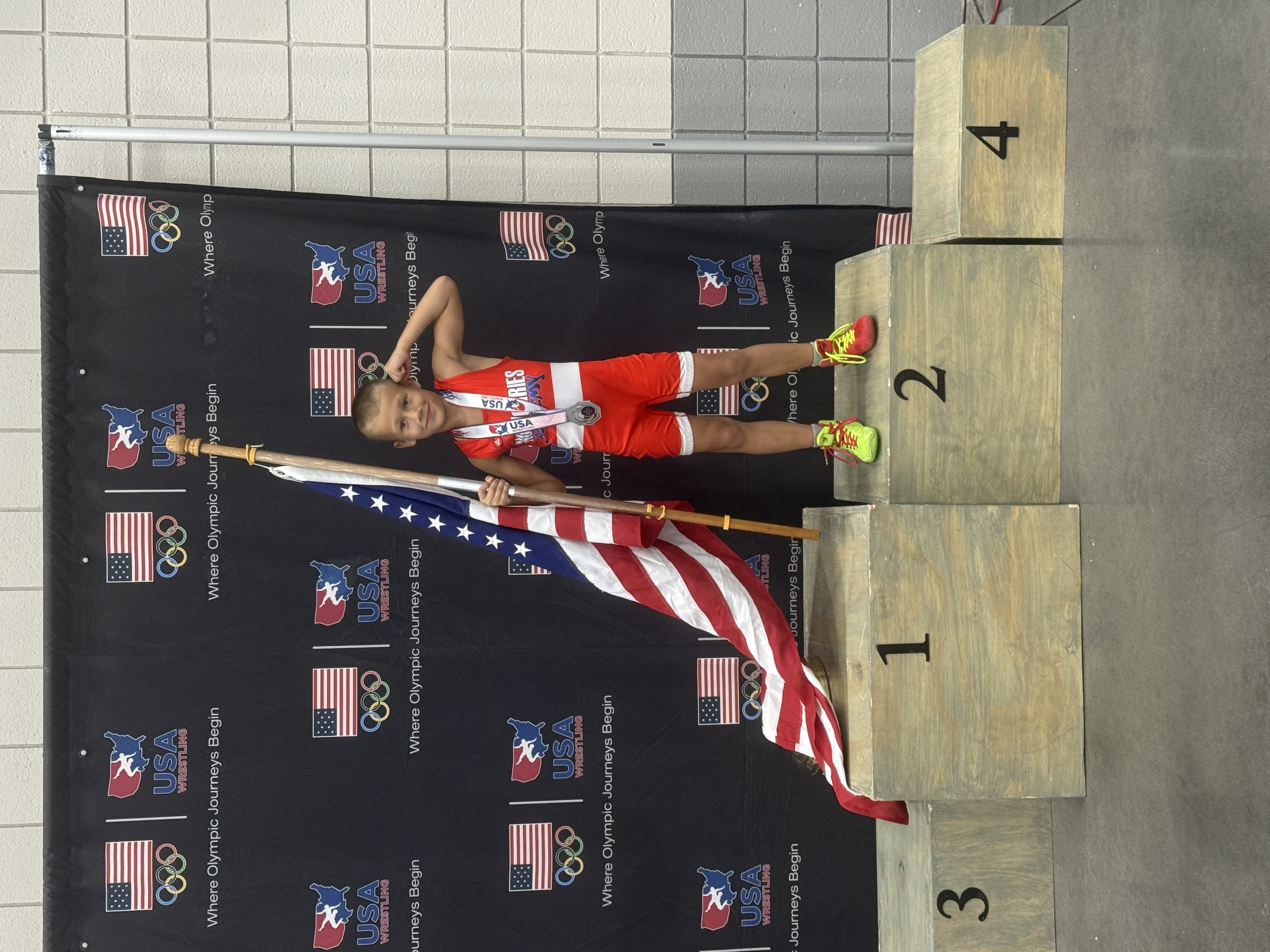 NoWorries Academy youth wrestler on USA Wrestling podium