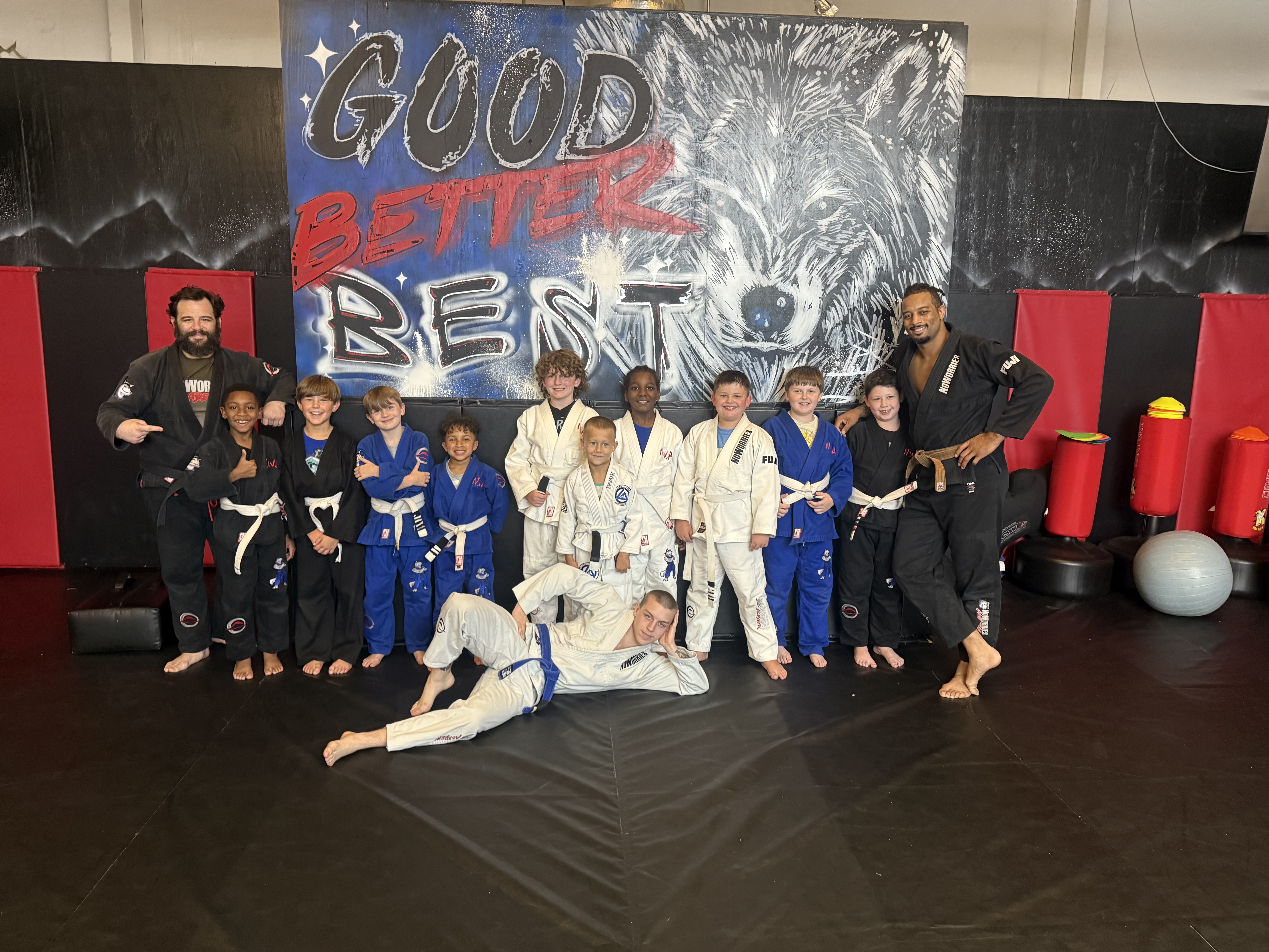 Coach working with youth BJJ students