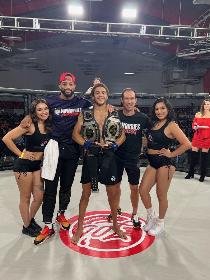 Majid Corbett with championship belts after MMA win