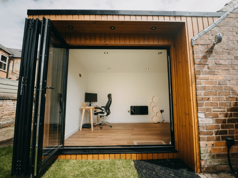 Cosy garden office with rugs and curtains for extra warmth