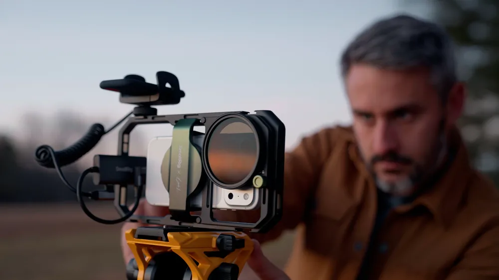 Justus McCranie filming with an iPhone in a SmallRig cage on a tripod
