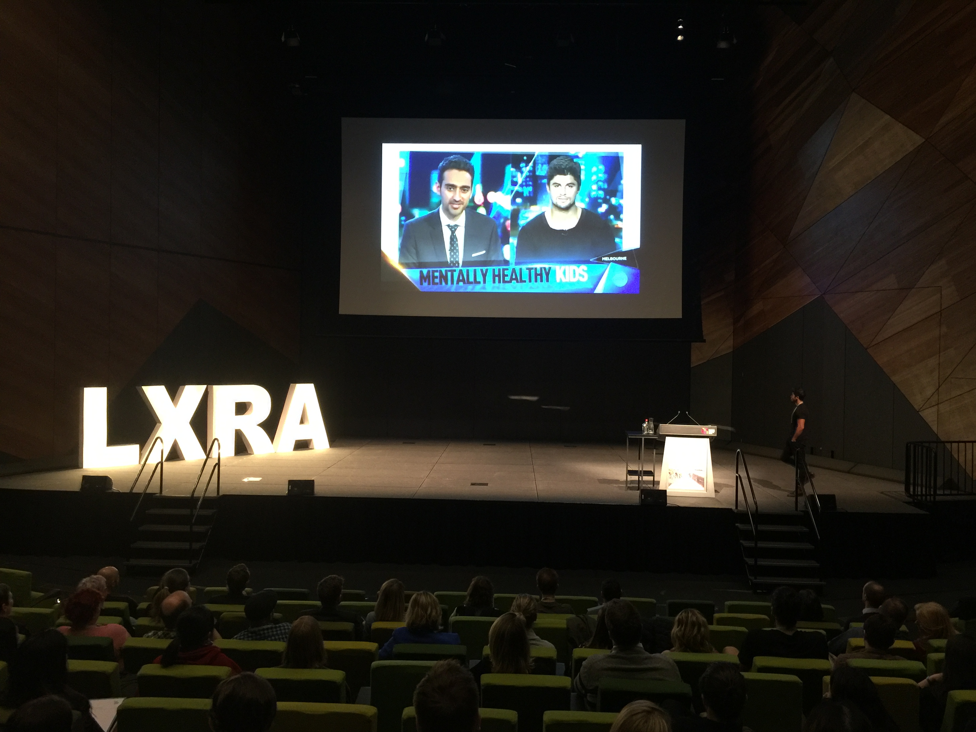 Nick Bracks speaking on stage