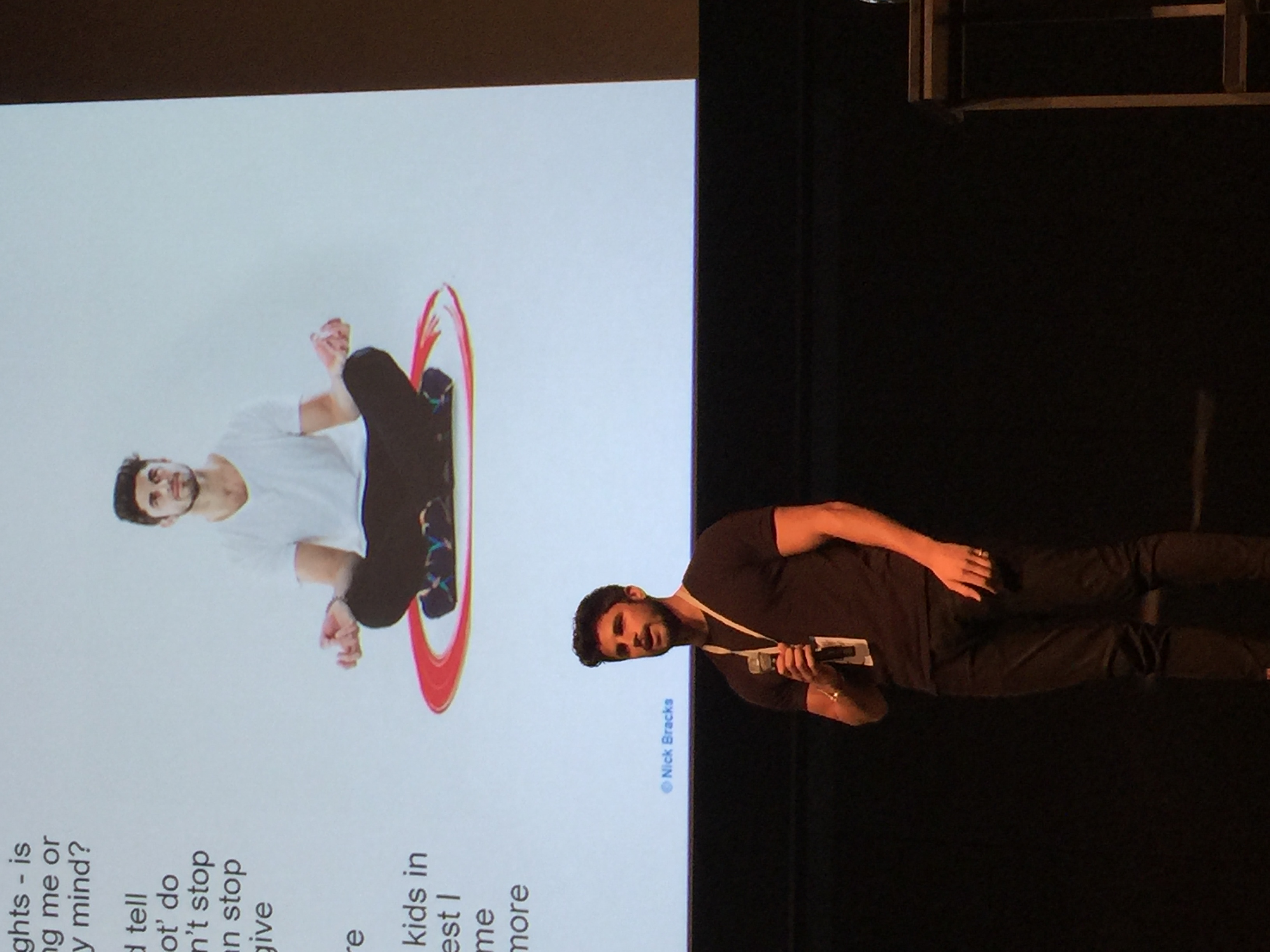 Nick Bracks speaking on stage
