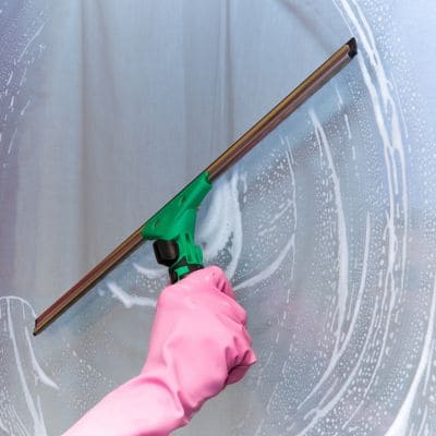 Commercial window being cleaned with a squeegee