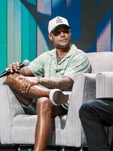 Jordan Poyer speaking on stage under blue light