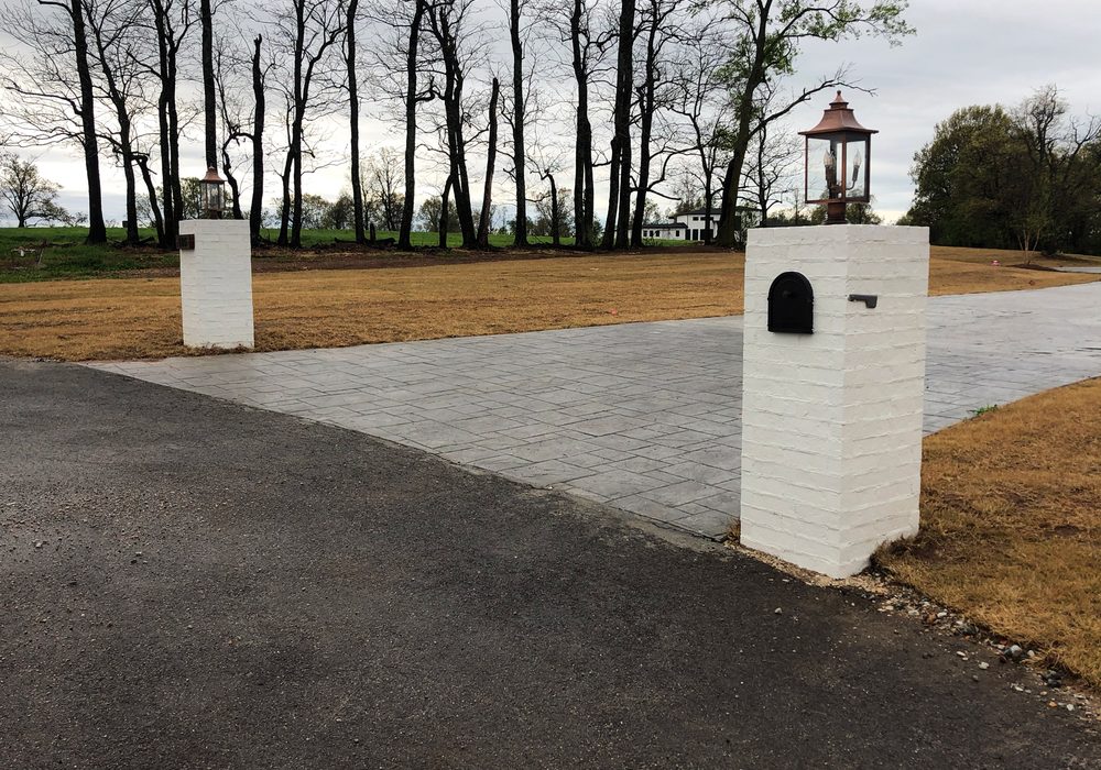 Driveway entrance with white brick columns
