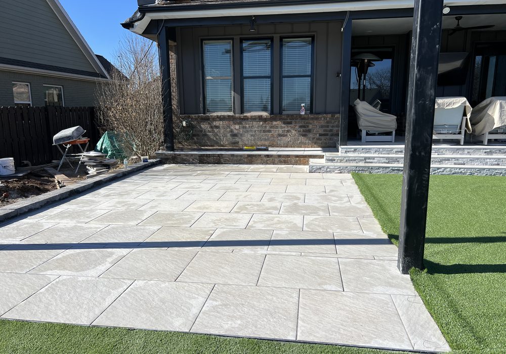 Covered patio with large format pavers and turf