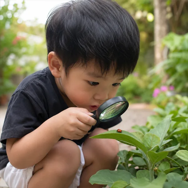 Child exploring with a magnifying glass