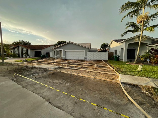 After: finished modern concrete driveway with turf inlays by Concrete Designs LLC