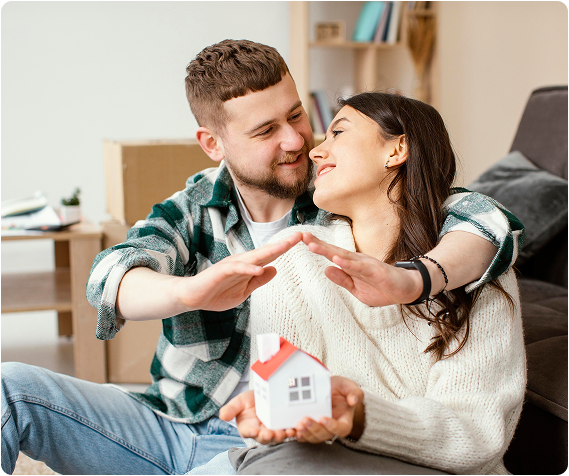 Couple holding a house model