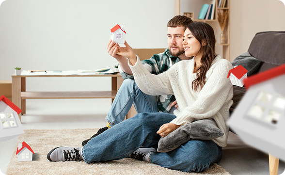 Couple holding house model