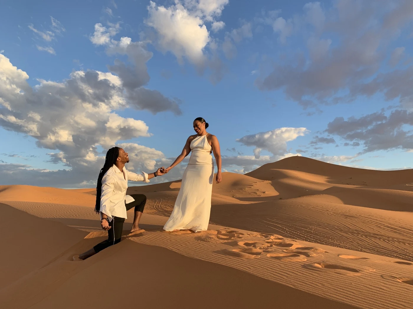 Kes and Jaz together in a wide desert landscape.