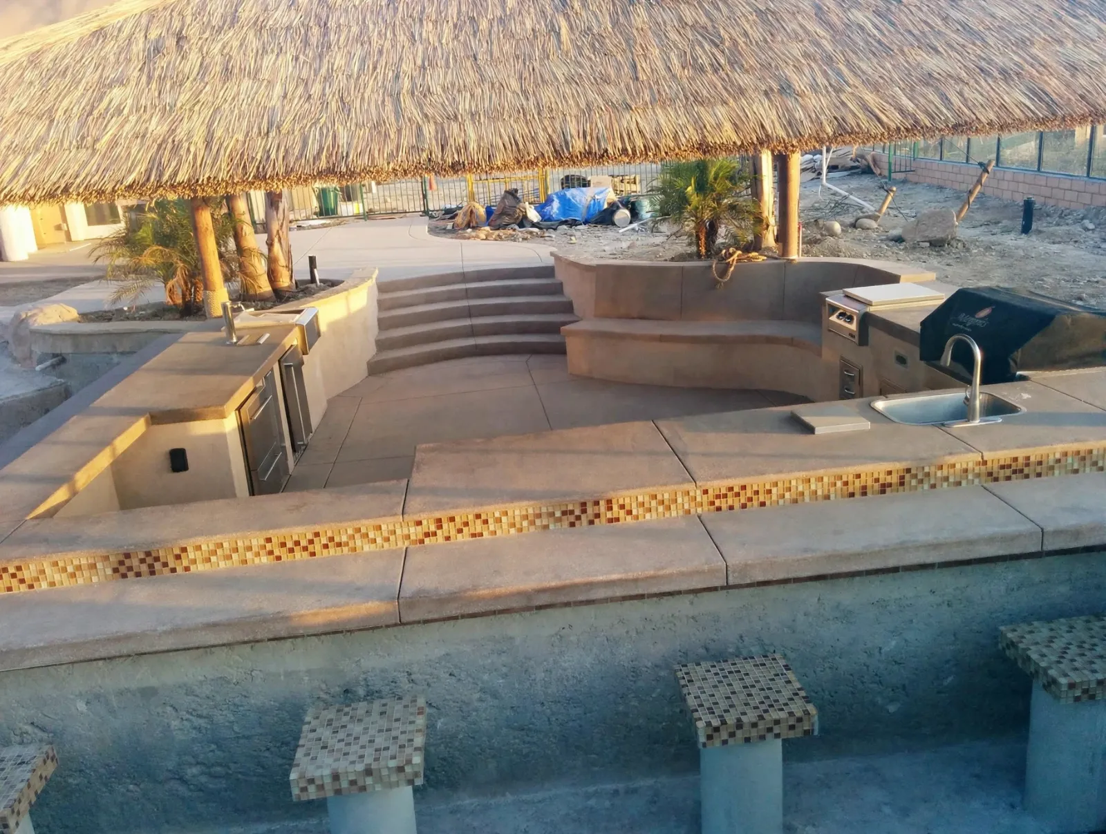 Swim-up bar and grill station under a palapa roof