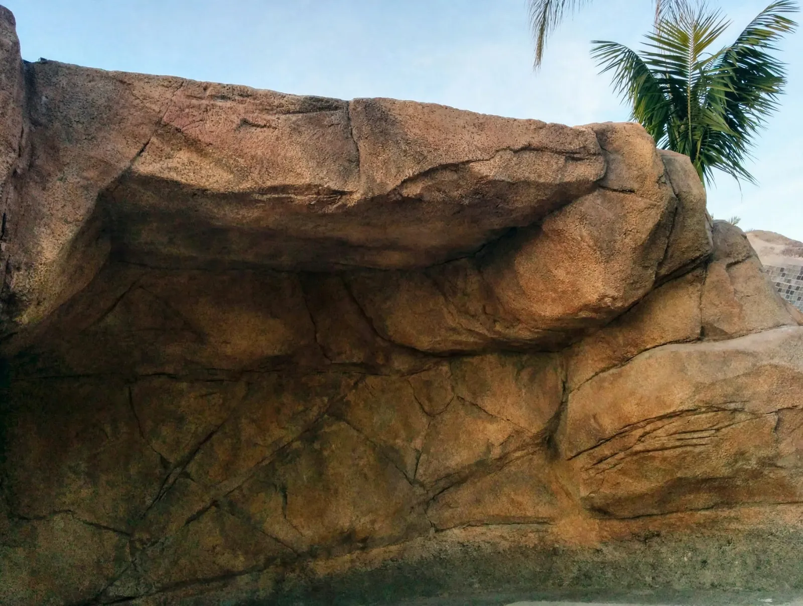Close view of hand-carved faux rock with cracks and color layers
