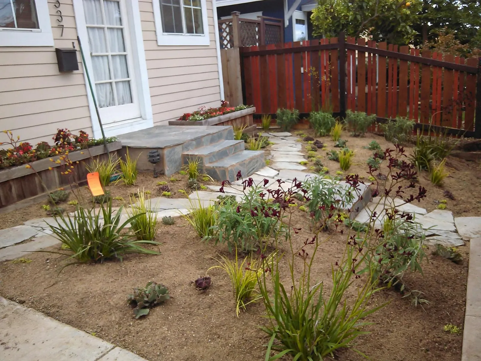 Front yard with a flagstone path and stone entry steps