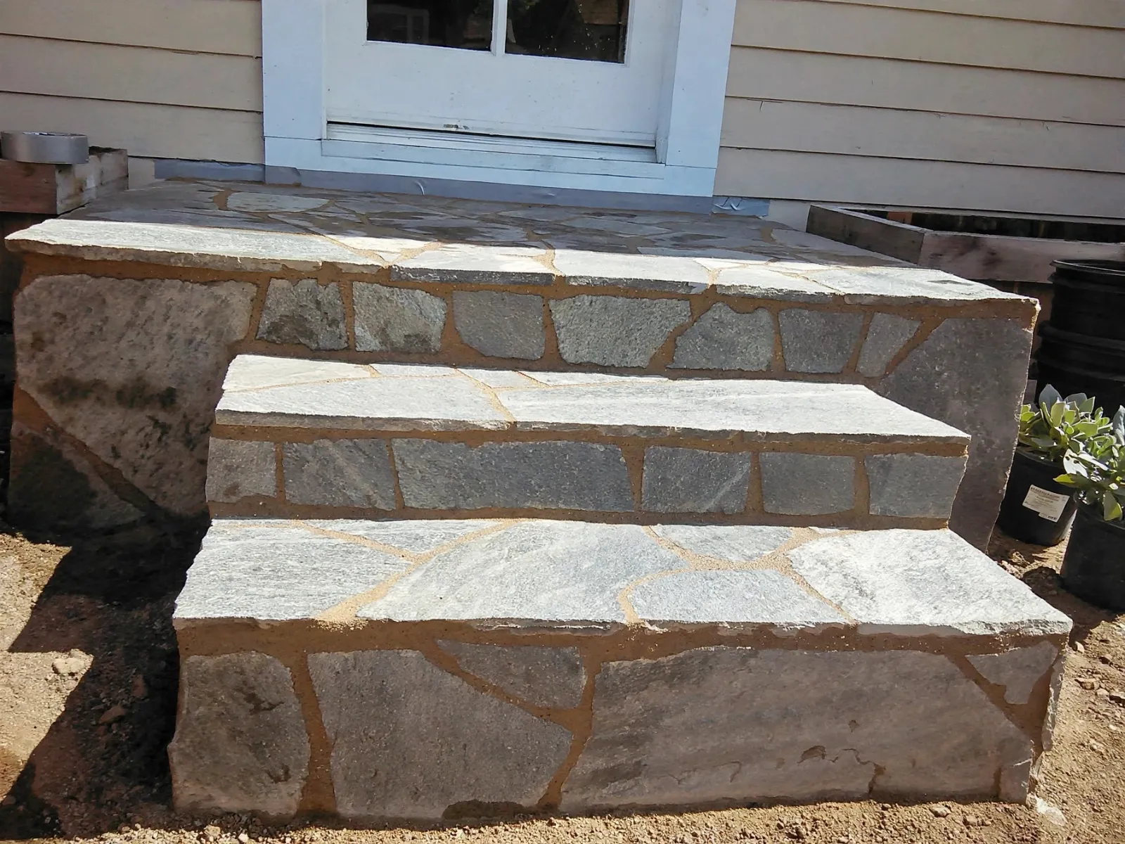 Wide flagstone porch steps at a front door