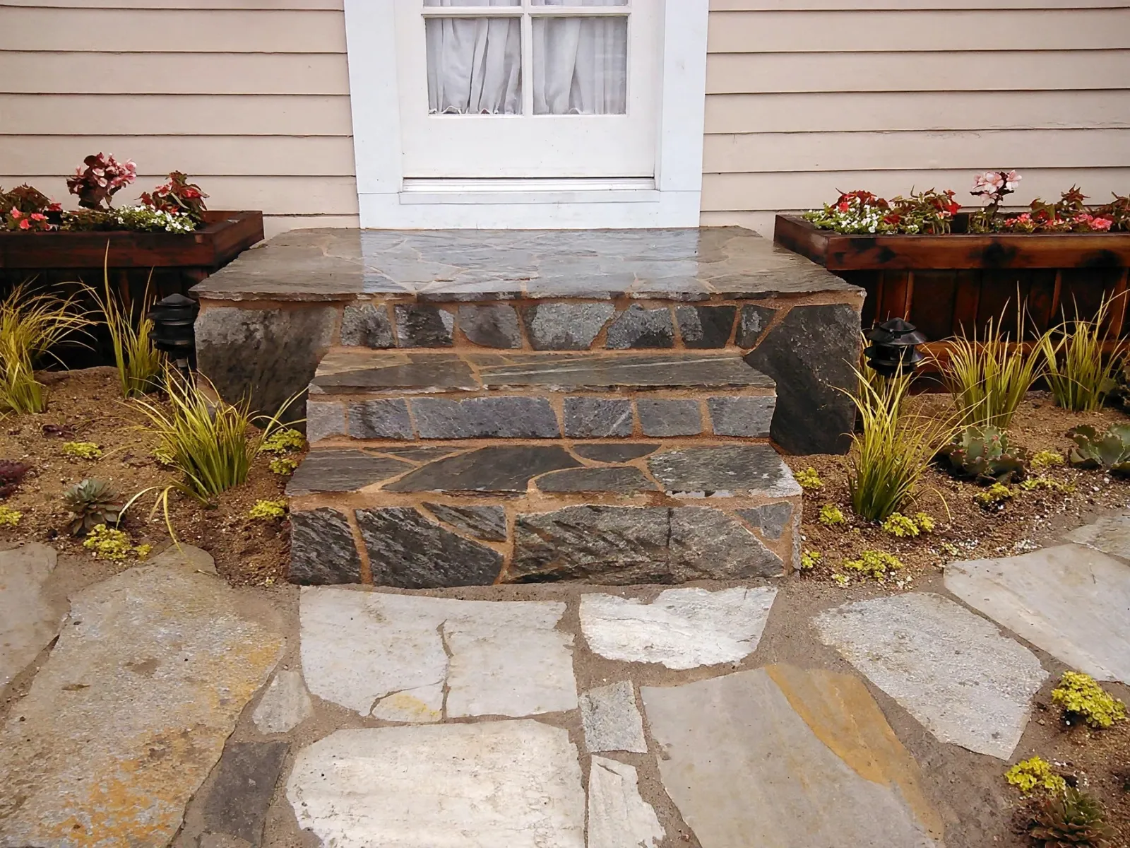 Natural stone entry steps with planters on each side