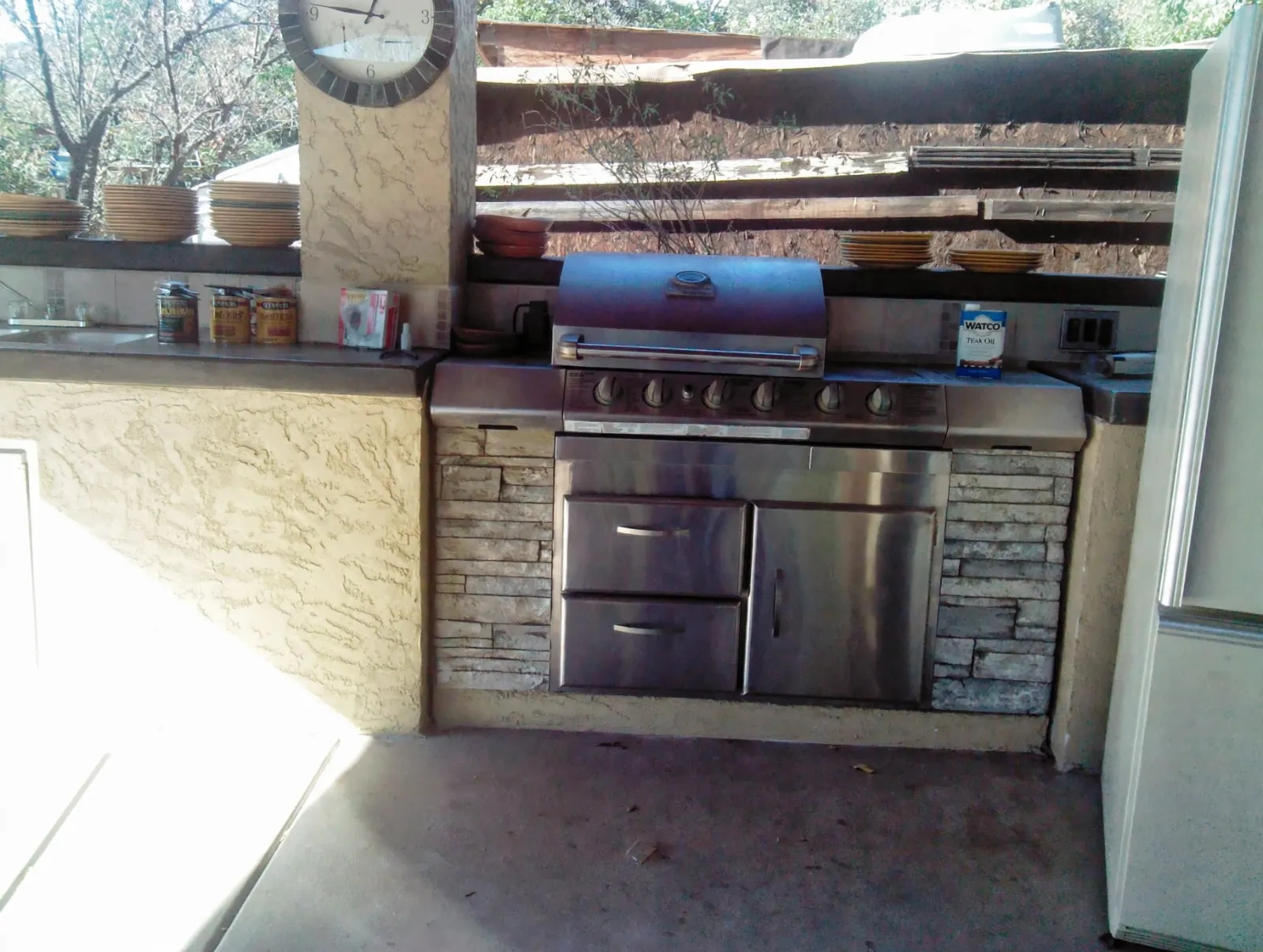Built-in grill station with stone shelves above