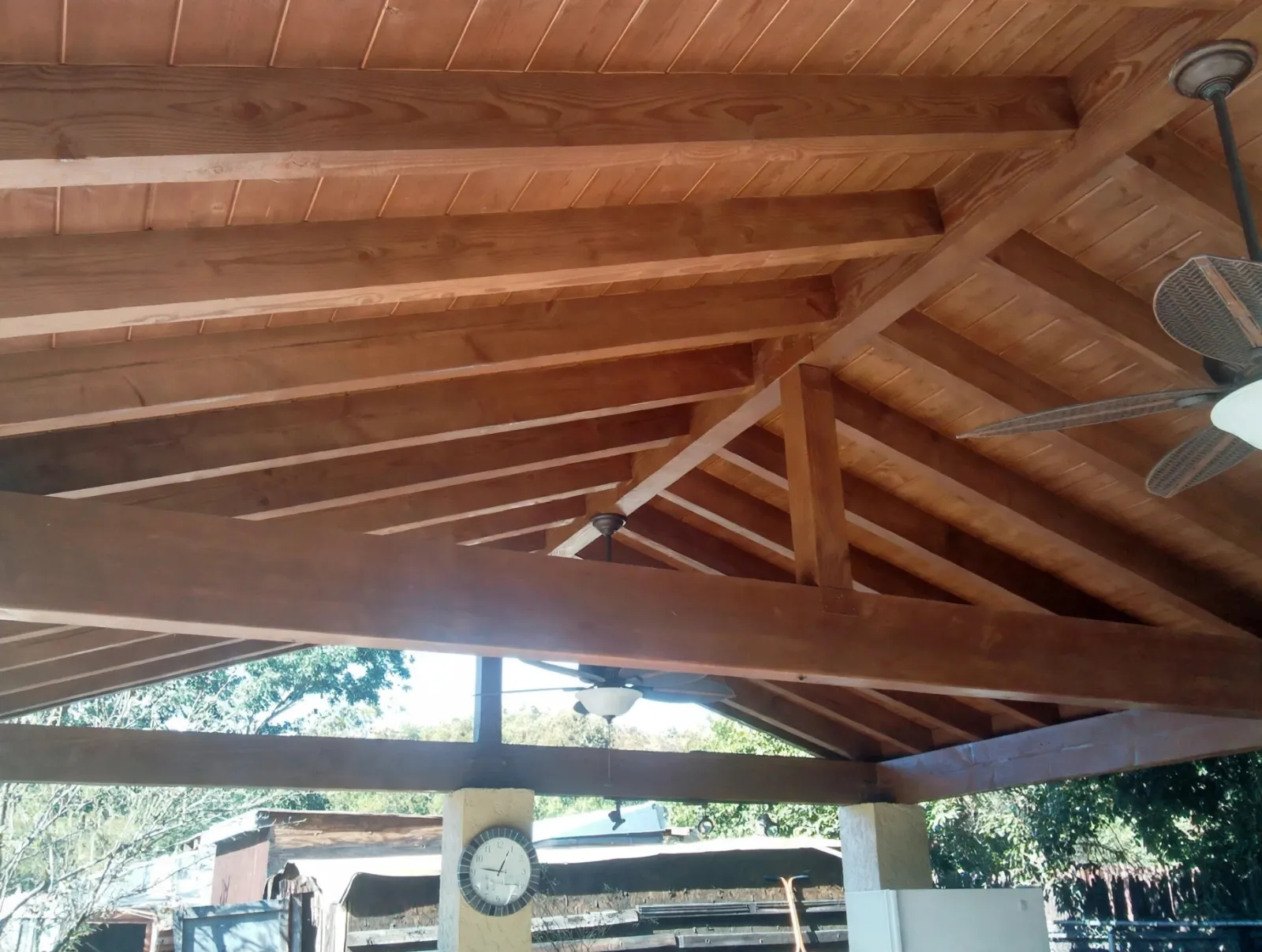 Exposed wood beams on the underside of a patio cover