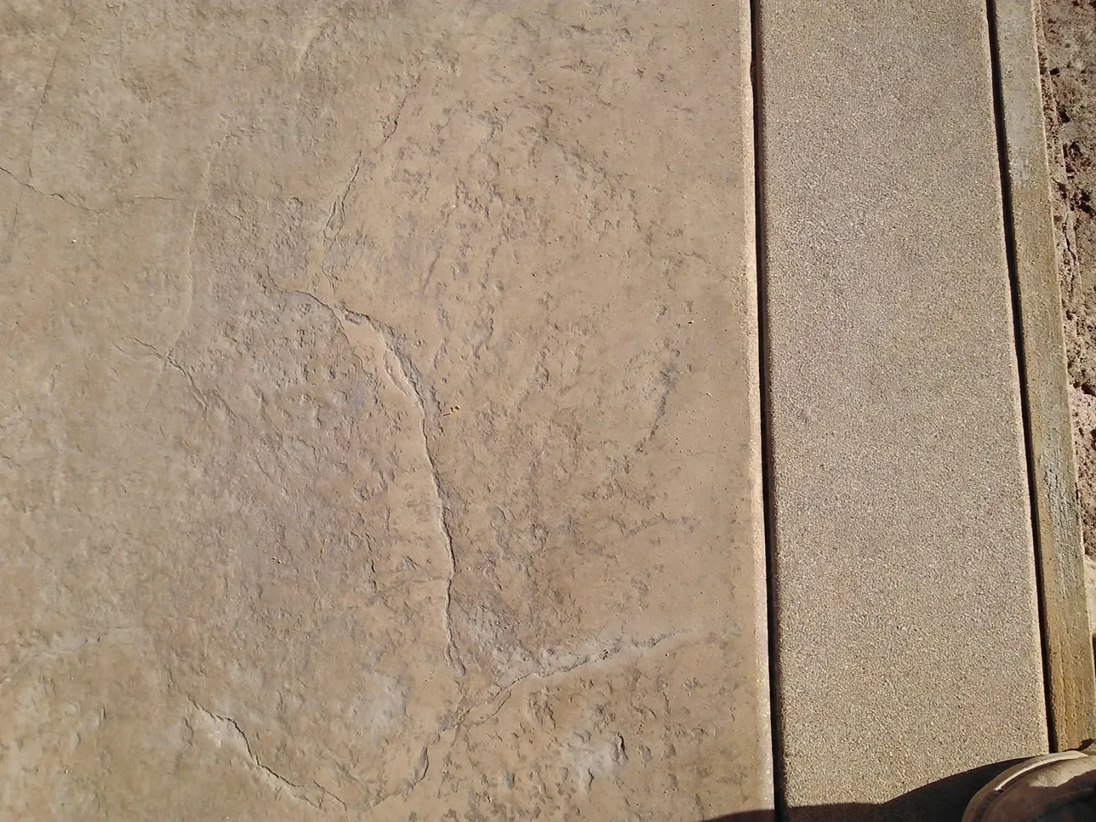 Close view of a stone texture stamped into concrete