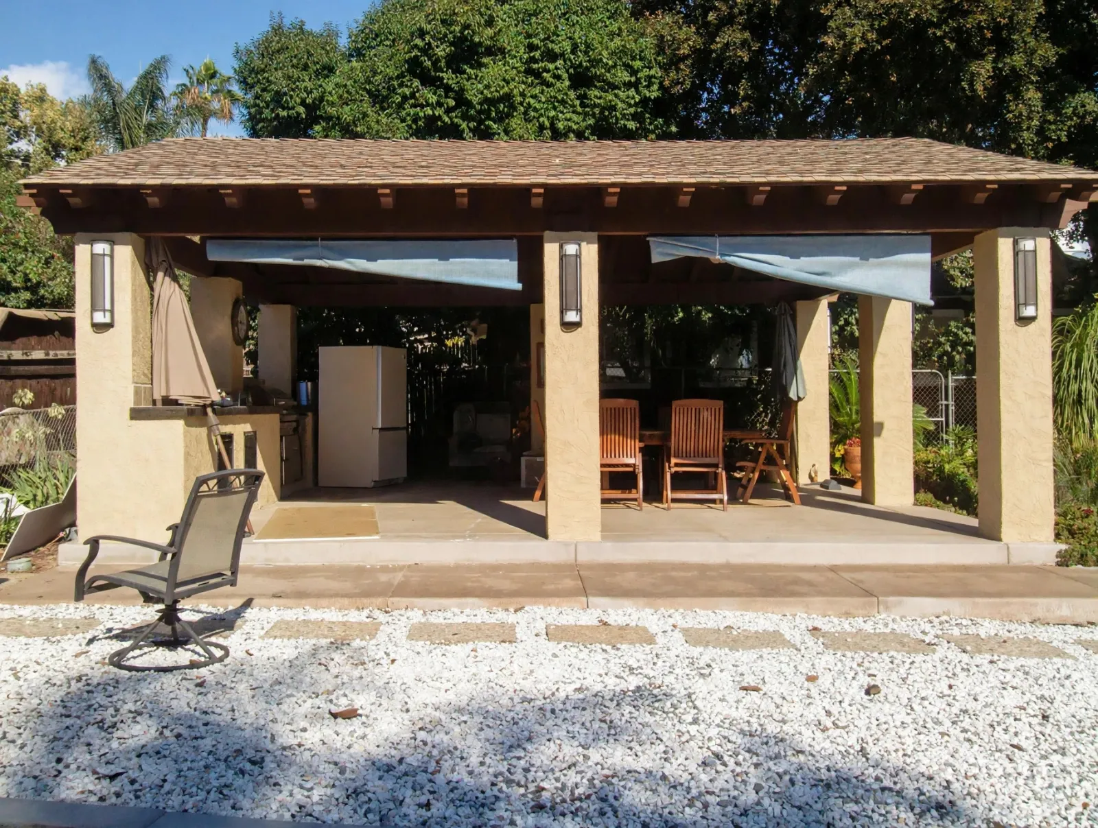 Patio cover on stucco columns over an outdoor dining area