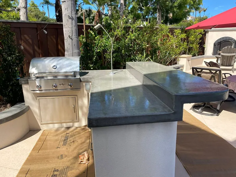 Polished concrete countertop on a stucco grill island