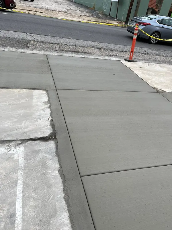 Fresh concrete apron poured at a street edge, Hot Springs