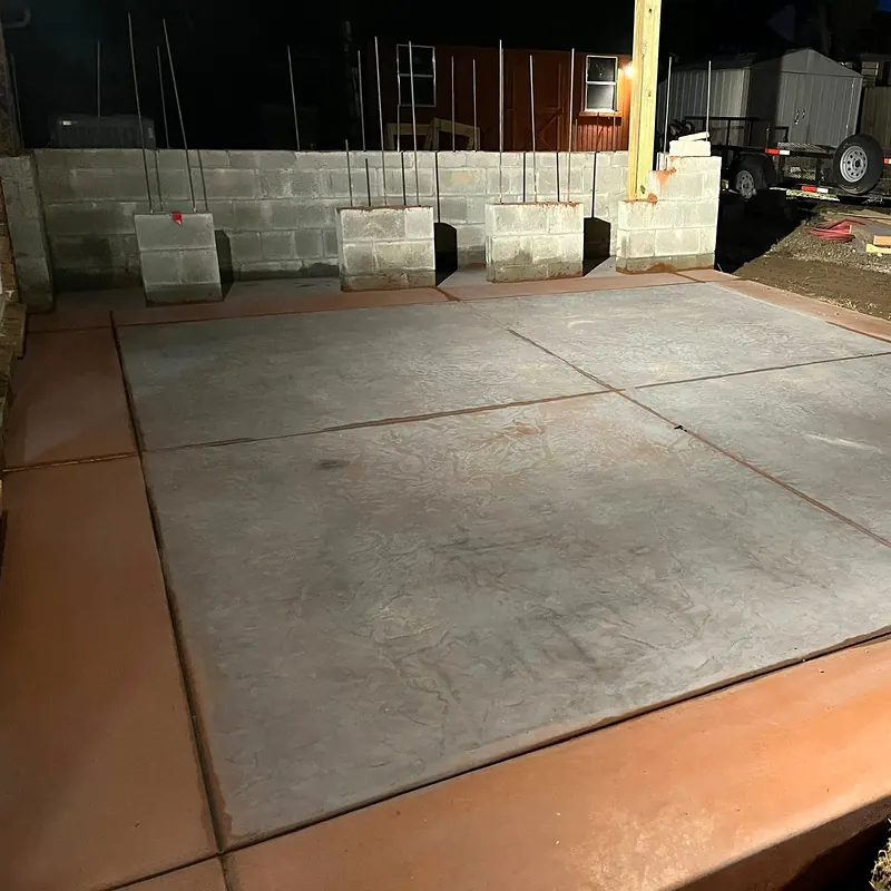 Stamped gray concrete patio slab with a terracotta colored border